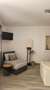 a living room with a couch and a tv at Apartments No 55 in Baška