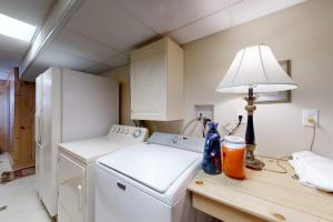 a kitchen with a refrigerator and a lamp on a counter at Shang-Rye-La in Rye +93 photos