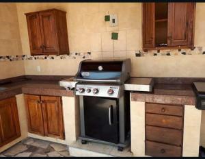 a kitchen with a grill on top of a stove at Mar Real Suites Guayabitos in Rincon de Guayabitos