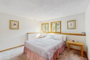 a bedroom with a large bed and a table at Nature's Getaway in Bartlett
