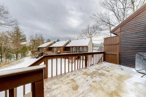 a balcony of a house with snow on it at Nature's Getaway in Bartlett