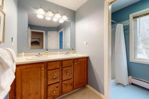 a bathroom with two sinks and a mirror at The Ski Haus in Jackson +40 photos