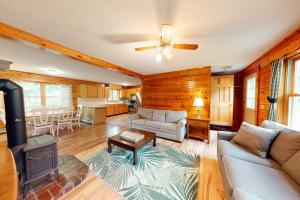 a living room with a couch and a table at Riverside in Cornish