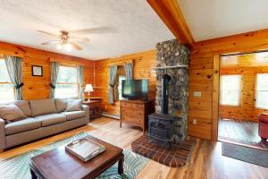 a living room with a couch and a fireplace at Riverside in Cornish