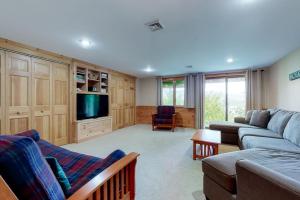 a living room with a couch and a tv at Mountain Vista in Bartlett