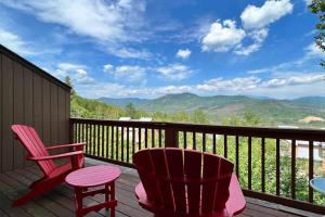 two chairs and a table on a deck with mountains at Mountain Vista in Bartlett