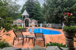 a pool with a statue and chairs and a fountain at The Rest in Jackson