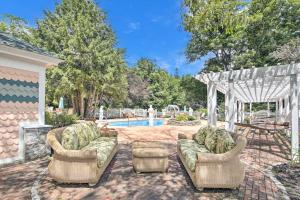 a backyard with two couches and a swimming pool at The Rest in Jackson