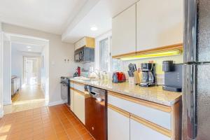 a kitchen with white cabinets and a counter top at Tin Mountain Treetops Time in Jackson