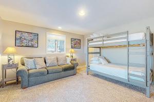 a bedroom with a bunk bed and a couch at Tin Mountain Treetops Time in Jackson