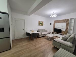 a living room with a couch and a table at Vila Mollanji in Tirana