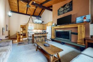 a living room with a fireplace and a kitchen at Mountain Oasis in Bartlett
