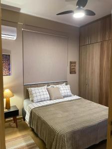 a bedroom with a bed and a ceiling fan at BeM Ipanema in Rio de Janeiro +36 photos