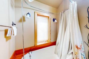 a bathroom with a bath tub and a window at Kootenai Haus in Sandpoint +98 photos