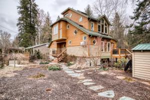 a large wooden house in the middle of a yard at Kootenai Haus in Sandpoint