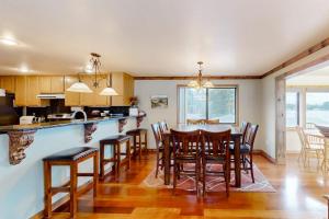 a kitchen and dining room with a table and chairs at On the Shoreline in Cocolalla