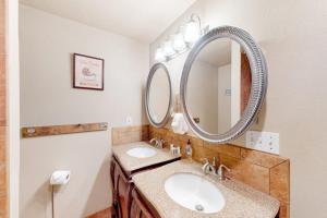 a bathroom with two sinks and a large mirror at On the Shoreline in Cocolalla +75 photos