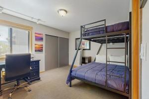 a bedroom with two bunk beds and a desk and a chair at Trail & Tee Retreat in Sun Valley +55 photos