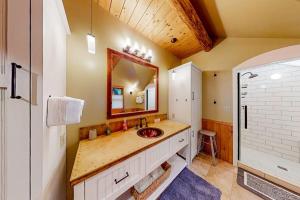 a bathroom with a sink and a mirror at Eureka Lodge in Sagle +84 photos