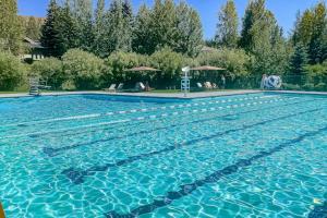 a large swimming pool with blue water at Valley Gem Entire Home in Sun Valley