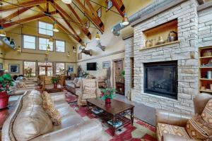 a large living room with a large stone fireplace at Hailey Haus in Hailey