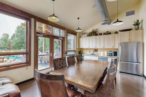 a kitchen with a wooden table and a refrigerator at Hailey Haus in Hailey