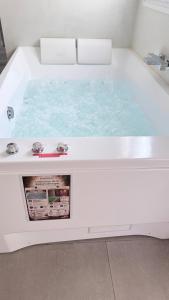 a white bath tub with at SPA JUNGLE in Le Mesnil-Saint-Denis +27 photos