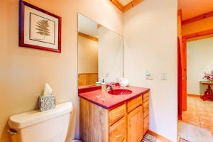 a bathroom with a sink and a toilet and a mirror at White Mountain Log Home in Carroll +58 photos