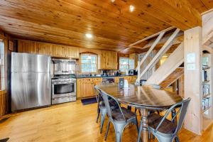 a kitchen with a table and a stainless steel refrigerator at Maggie in Wakefield