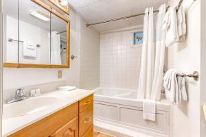 a white bathroom with a tub and a sink at Rustic Escape in Franconia +85 photos