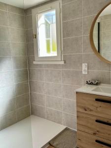 a bathroom with a sink and a mirror at Maison avec jardin à 5 min à pied de la plage, clim et parking in Royan +22 photos