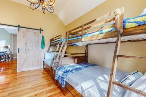 a bedroom with bunk beds in a house at Saco River & White Mountain Views in Conway