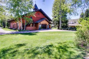 a large house with a grass yard in front of it at Elkhorn Escape in Sun Valley