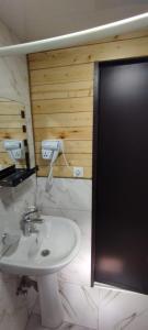 a bathroom with a white sink and a black door at Sno Valley Cottage in Sno +18 photos