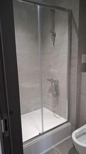 a shower with a glass door in a bathroom at Modern Studio Apartment with En-Suite in Peterborough