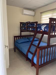 a bedroom with two bunk beds with blue sheets at The Sailor beach House Just 35 Minutes from Panama City! in Vacamonte +7 photos