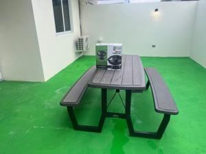 a wooden table with a box on it on a green floor at The Sailor beach House Just 35 Minutes from Panama City! in Vacamonte