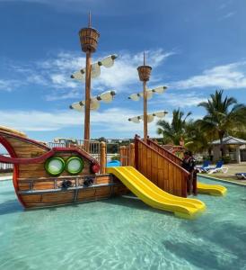 a water park with a slide in the water at The Sailor beach House Just 35 Minutes from Panama City! in Vacamonte