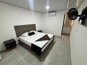a bedroom with a large bed in a room at Hotel Logistico in Santa Marta