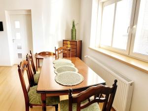 a dining room with a table and chairs and a window at Apartment by the lake in Píšťany