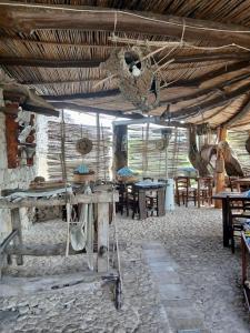 a room with tables and chairs and a ceiling at Ovile Juanne Loddo in Orosei