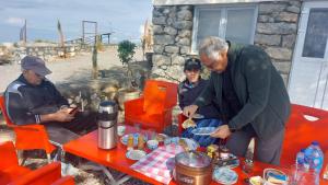 a group of people sitting around a table with food at HYN Mountain Resort in Kohāla