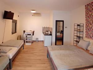 a living room with two beds and a kitchen at House for us Vinci 1 in Vinci