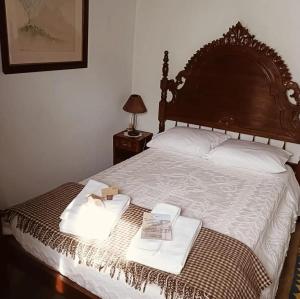 a bedroom with a bed with two trays on it at Casa dos avós 23 in Castro Daire