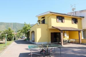 a building with a ping pong table in front of it at Villa Troianiello in Carano