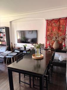 a living room with a table and chairs and a couch at Spacious Flat in West Kensington in London