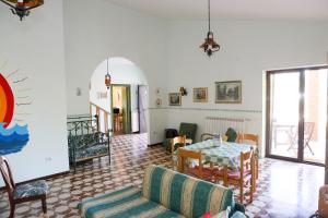 a living room with a table and chairs at Villa Troianiello in Carano