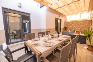 a dining room with a wooden table and chairs at Casa flor del Rocio in La Rinconada