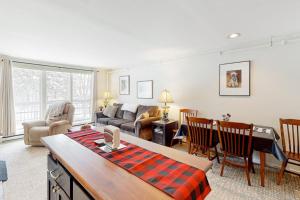 a living room with a couch and a table at Mountainside 20 in Warren