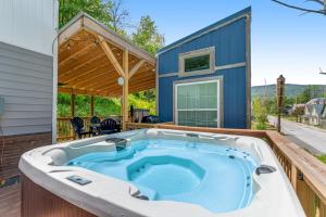 a hot tub on the deck of a house at Tiny Homes on Pleasant in Ludlow